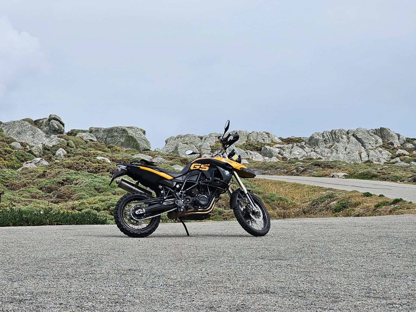 BMW GS motorcycle beside a rocky road in Galicia